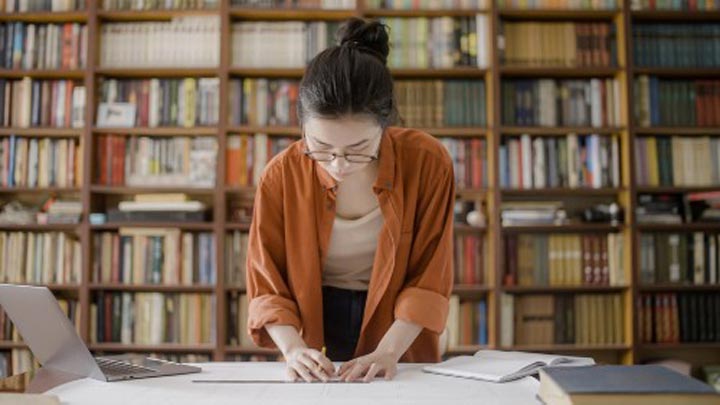 Female student studying in a library