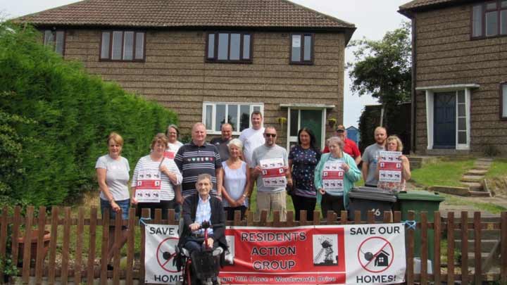A residents action group gathered outside a house on an estate.