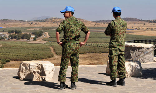 UN Peacekeepers looking out over a vista