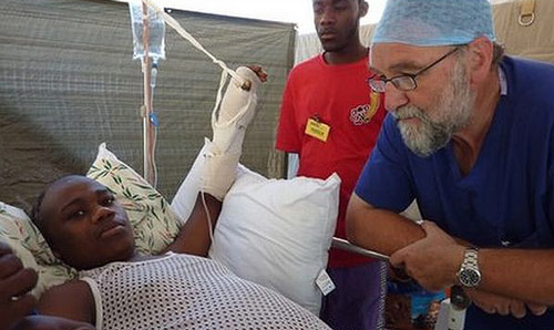 Emeritus Professor Tony Redmond attending to patient in Haiti