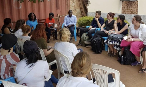 A group sat outside in a developing country